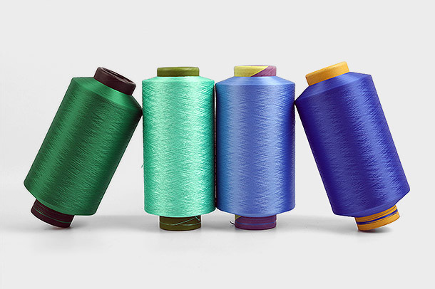 Dimensionsstabilitet är en viktig egenskap hos polyester DTY (Draw Textured Yarn) garn